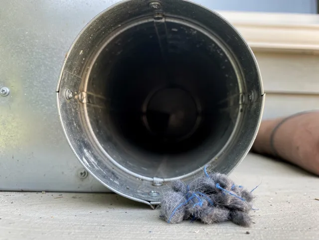 Meriden Dryer Vent Cleaning technician using specialized equipment to clear severe dryer vent blockage in Meriden